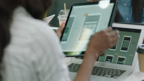 young-african-american-engineers-developing-mobile-software-application-using-digital-tablet-computer-brainstorming-design-solution-sharing-ideas-collaborating-in-startup-office-meeting-close-up