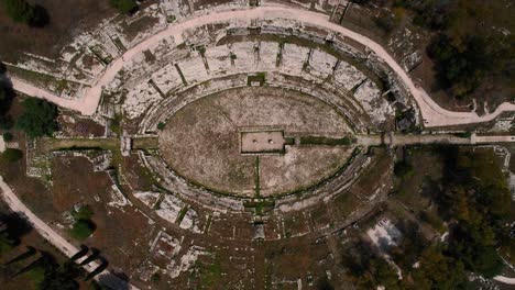 roman greek theater ruins in siracusa, sicily, italy. scenic aerial drone of historic amphitheater.
