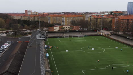 People-training-on-Malmo-soccer-field,-Sweden