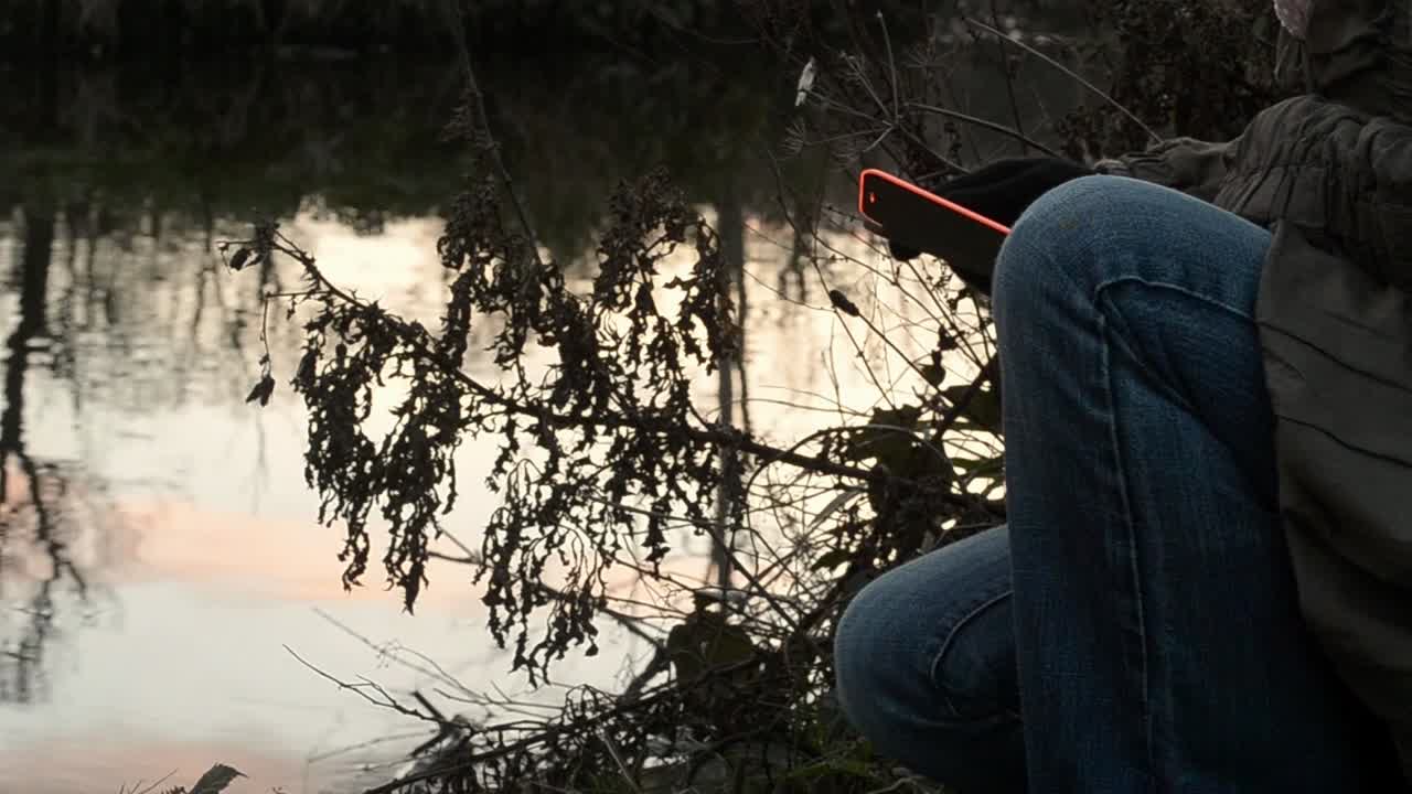 Utilizzo del cellulare in riva all'acqua.
