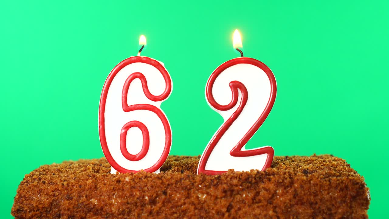 pastel con el número 62 vela encendida. llave de croma. pantalla verde. aislado