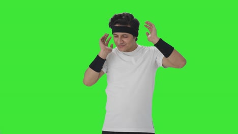 happy indian man doing neck exercise green screen