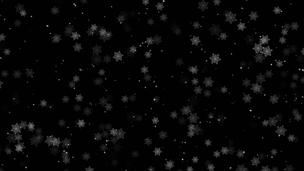 Dense flurry of snowflakes falls gently against isolated black background, creating a beautiful winter overlay for Christmas or holidays