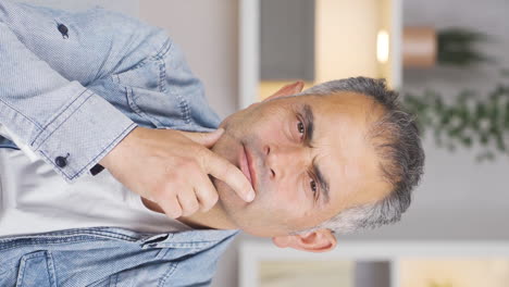 Vertical-video-of-Thoughtful-man-towards-the-camera.