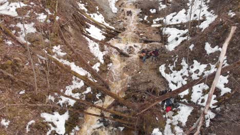 musicians by a mountain stream in winter