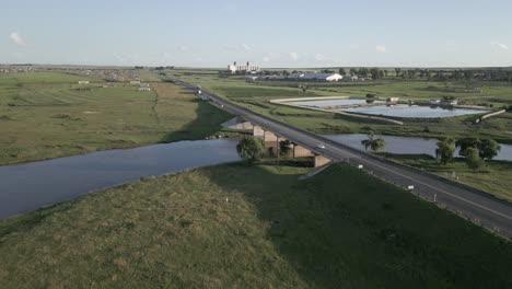 Low-flight-approaches-highway-bridge-over-Vaal-River,-Villiers,-ZA