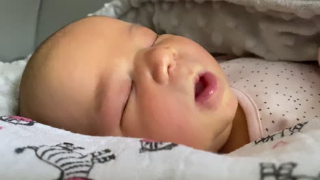 cute baby girl sleeping peacefully in her bed - close up shot