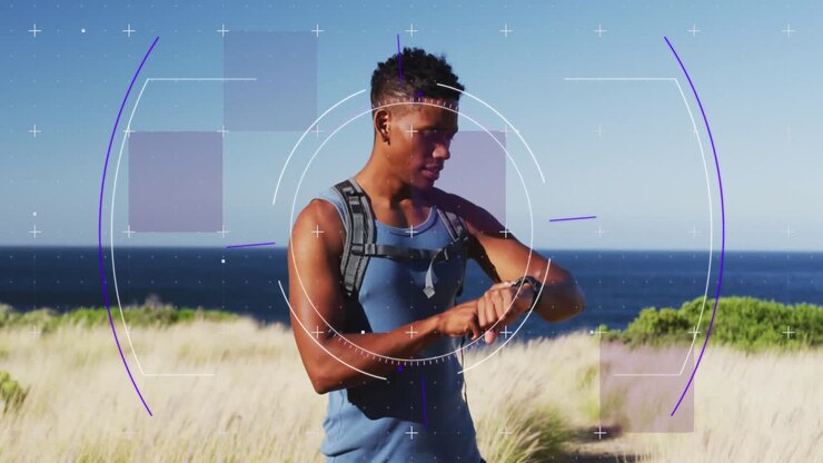 Animation of viewfinder over african american man checking smartwatch outdoors