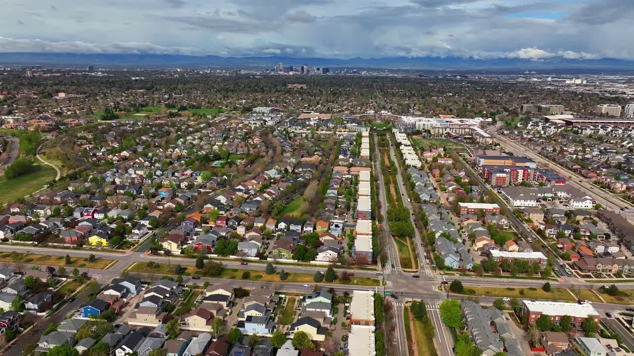 Front Range Denver Lowry Northfield Central Park neighborhood apartment buildings Colorado aerial drone sunny cloudy sky cloudy Lakewood Arvada Golden cars cityscape skyscrapers upwards motion