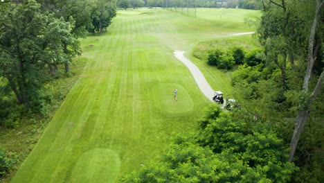 drone footage of golfer at tee box driving