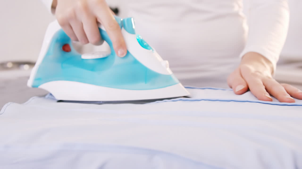 Close up on a woman doing the ironing 