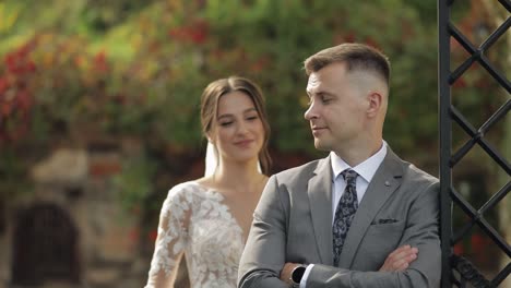 Lovely-newlyweds-caucasian-bride-embracing-groom-in-park-making-kiss,-wedding-couple-family-hugging