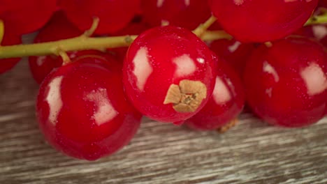 Super-close-macro-of-a-redcurrants-on-a-wooden-table.