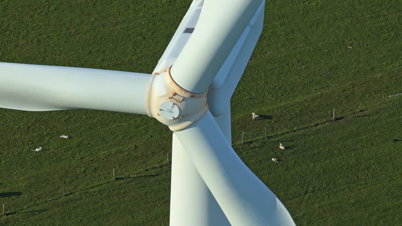 Close up aerial view of wind turbine blades turning
