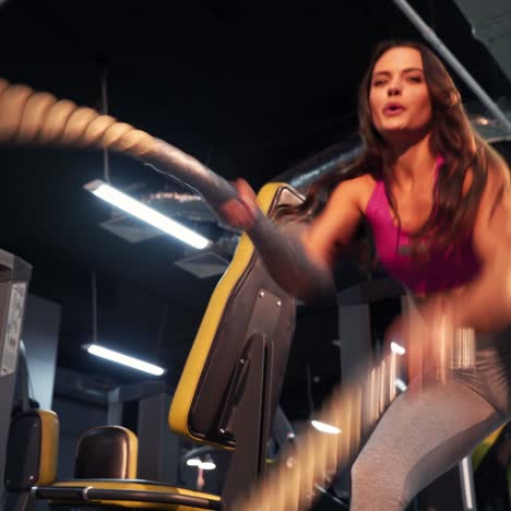 battle rope workout. women doing exercises using sports equipment - rope. ideal female figure