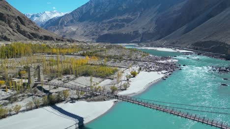 Aerial-view-of-a-wooden-bridge-outside-Skardu,-a-city-in-northern-Pakistan