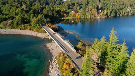 car crossing small scenic bridge over lake perito moreno