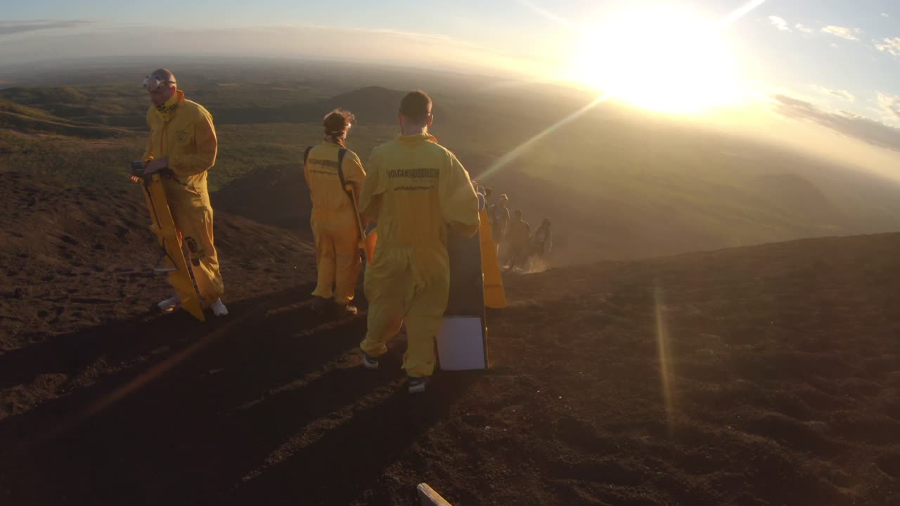 Sandboarding down a Volcano at Sunset