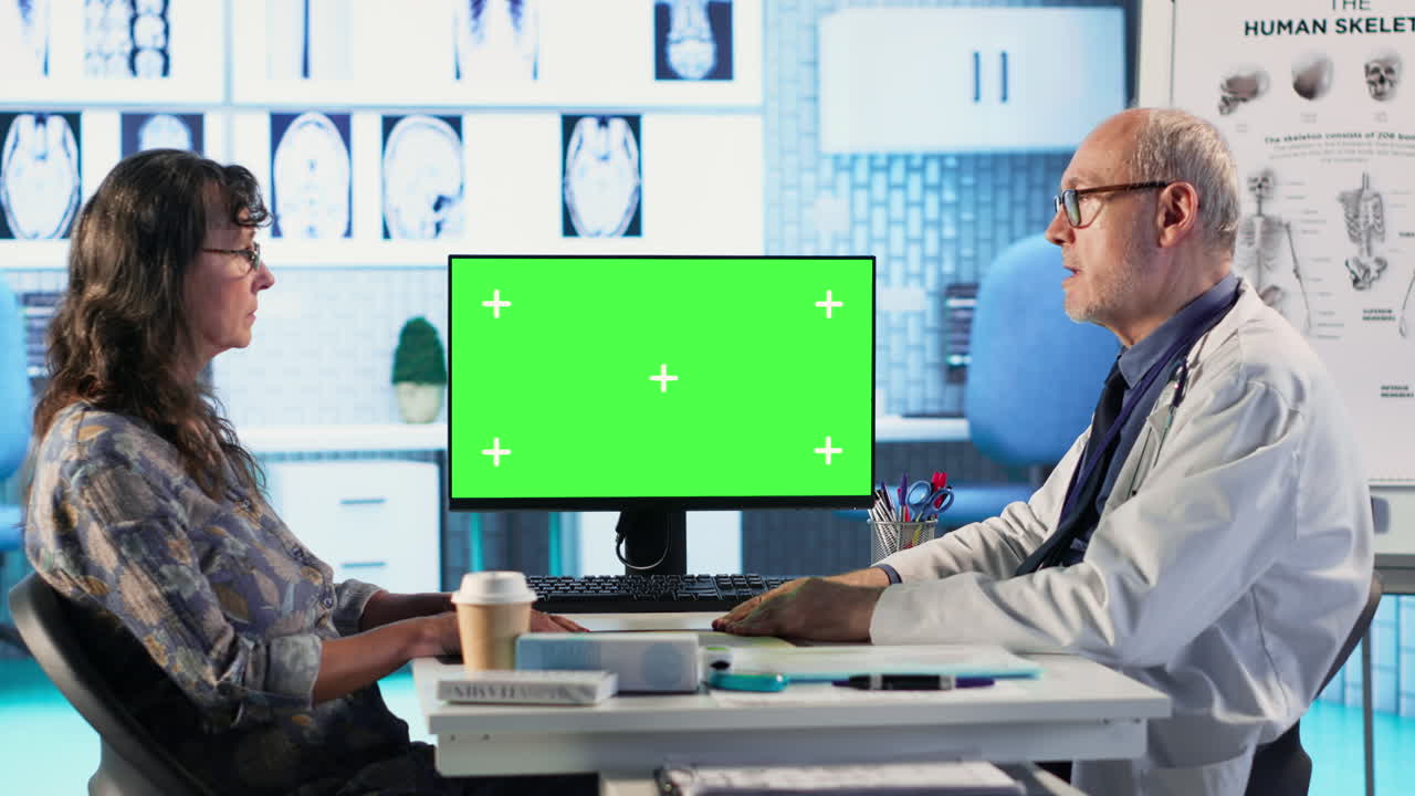 Senior physician consulting old lady next to mockup display in the cabinet