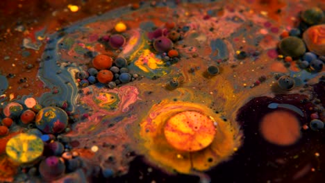 abstract colorful acrylic and food paint bubbles on water