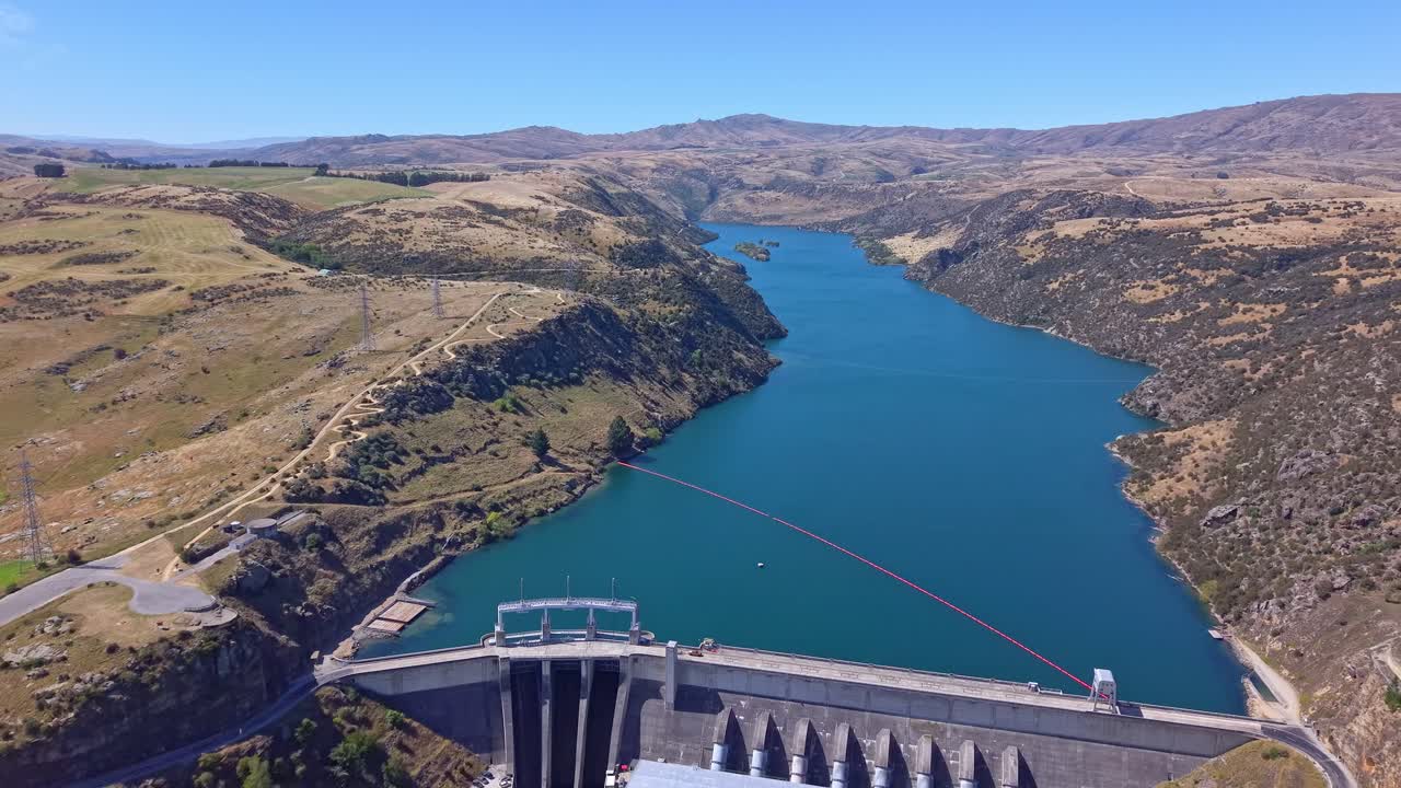 Encaptivating Aerial drone footage revealing a powerful, industrial hydroelectric dam producing renewable energy in New Zealand