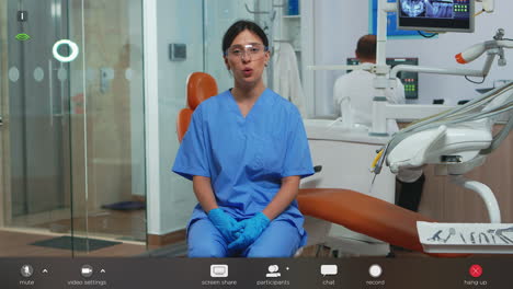 dental assistant looking at camera speaking with patients