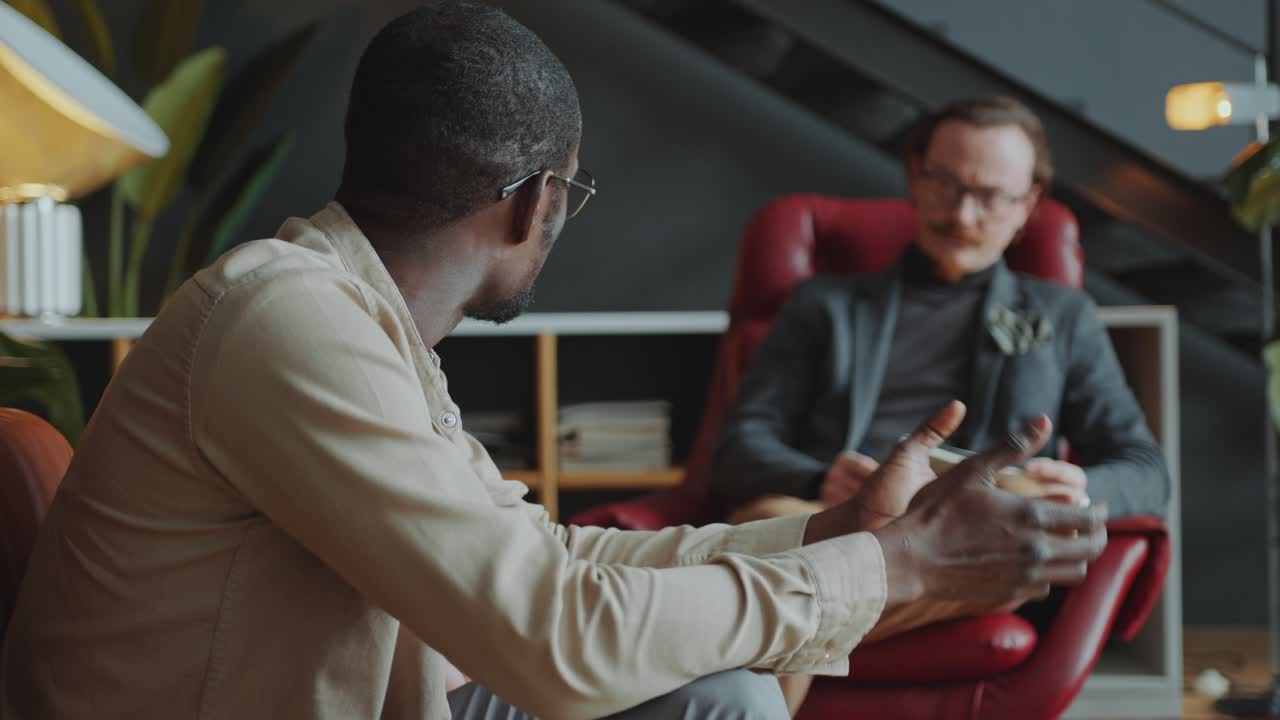 Black Man Telling about Life Problems to Therapist during Counseling Session