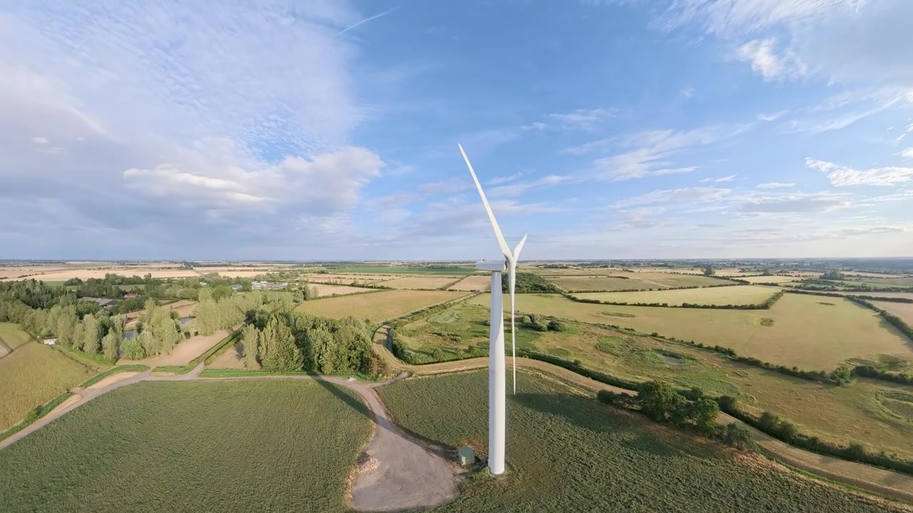 aerial drone footage, Sunset view over a field of renewable energy sources featuring wind turbines and natural scenery. Lincolnshire solar panel arrays wind turbines countryside, England