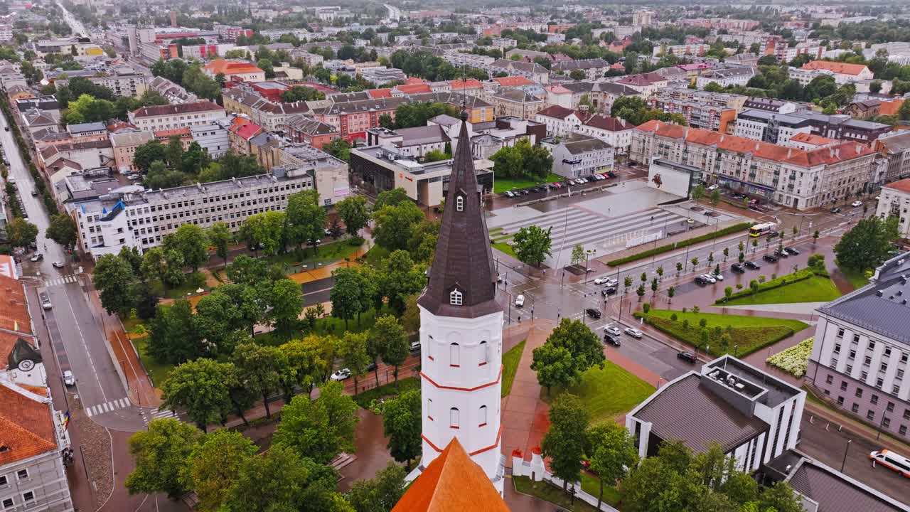 Rainy aerial cityscape of Siauliai with church tower and city square view