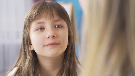 Little-girl-listening-to-mother's-advice.