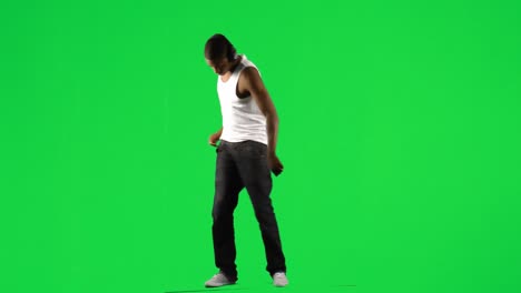 Ethnic-boy-with-a-headset-on-dancing-music-against-green-screen