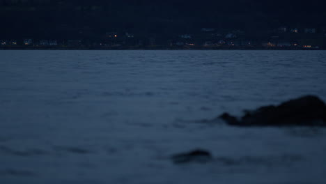 Seaside-town-with-rocks-in-foreground-and-water-all-around