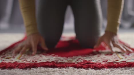 Muslim-Man-At-Home-Kneeling-On-Prayer-Mat-And-Praying-2
