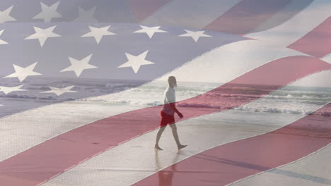 animation of flag of united states of america over senior african american man on beach