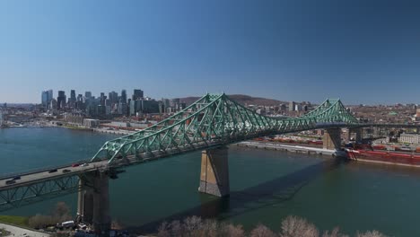 the jacques cartier bridge crossing the saint lawrence river from montreal island, car driving connection between metropolitan underground area