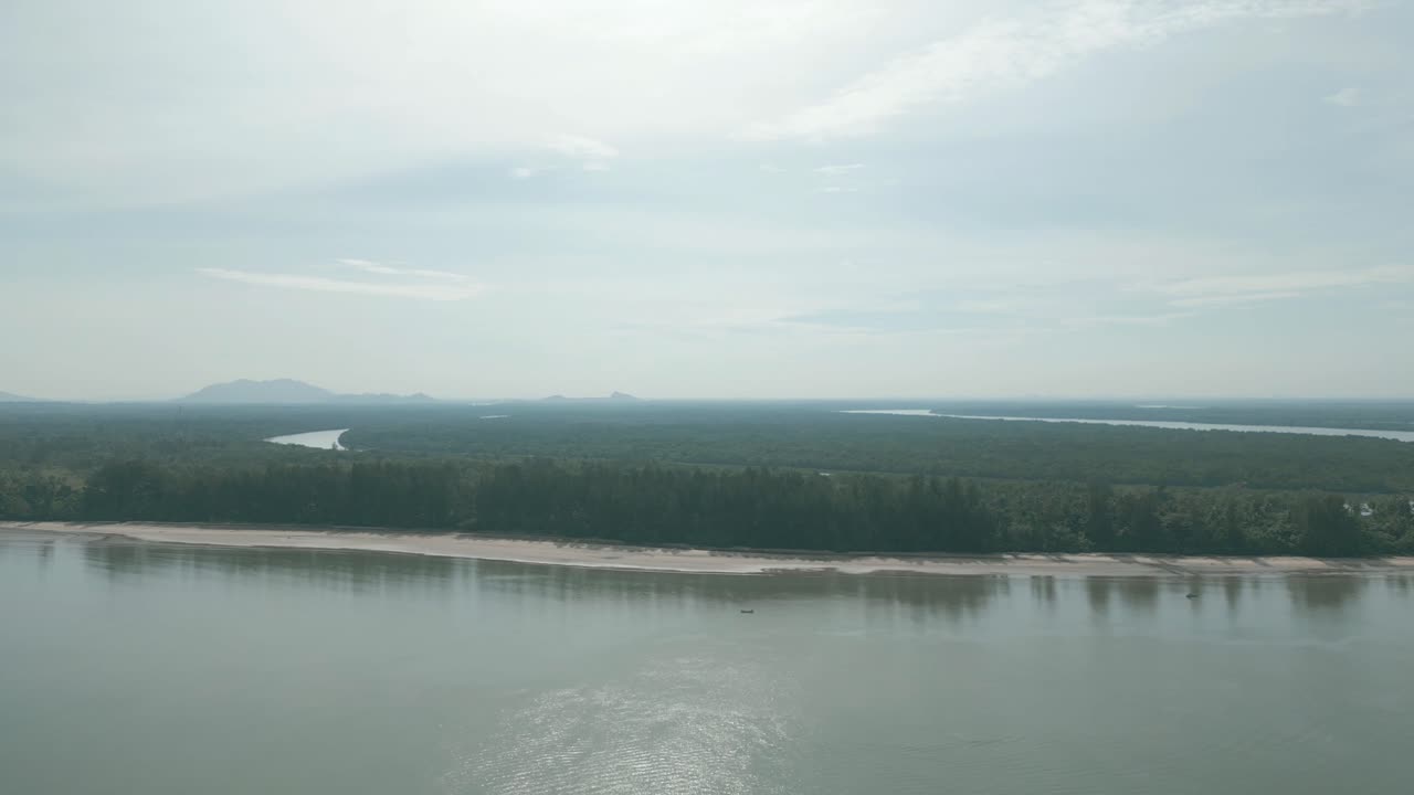 Drone View Of Paradise Beach Trombol,White Sandy Beach,Blue Sky And Green Coconut Trees,Telaga Air Fishing Village,Kuching,Borneo.