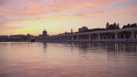 beautiful vibrant sunset over water walkway, palmeral de las sorpresas in malaga, spain