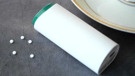 close-up of artificial sweetener tablets and container