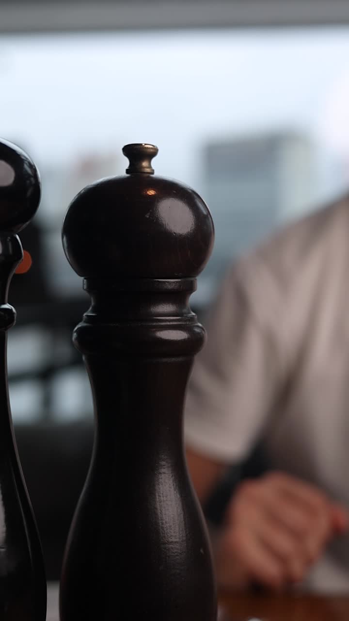 Person grinding pepper