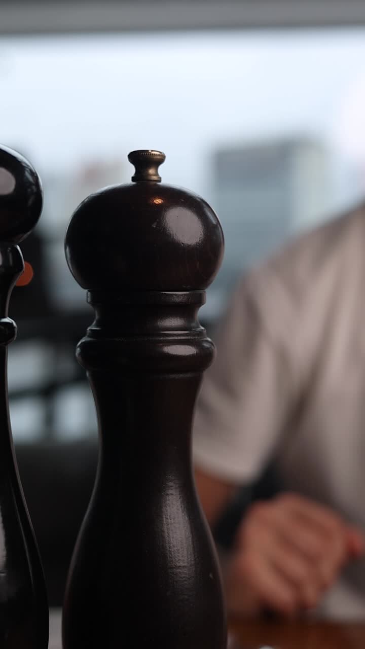Person grinding pepper