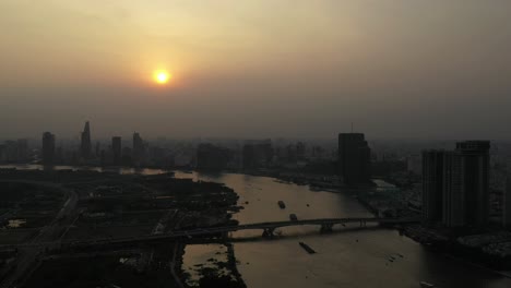 drone shot of saigon river smoggy sunset typical of a day with an extreme air pollution reading in southeast asia