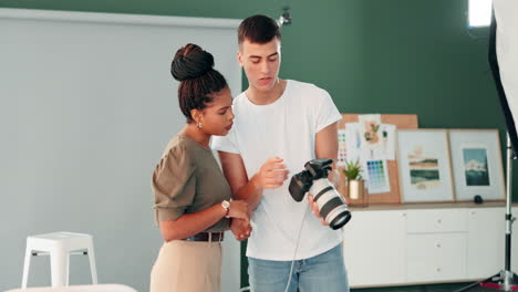 photographer and model in studio discussing photos