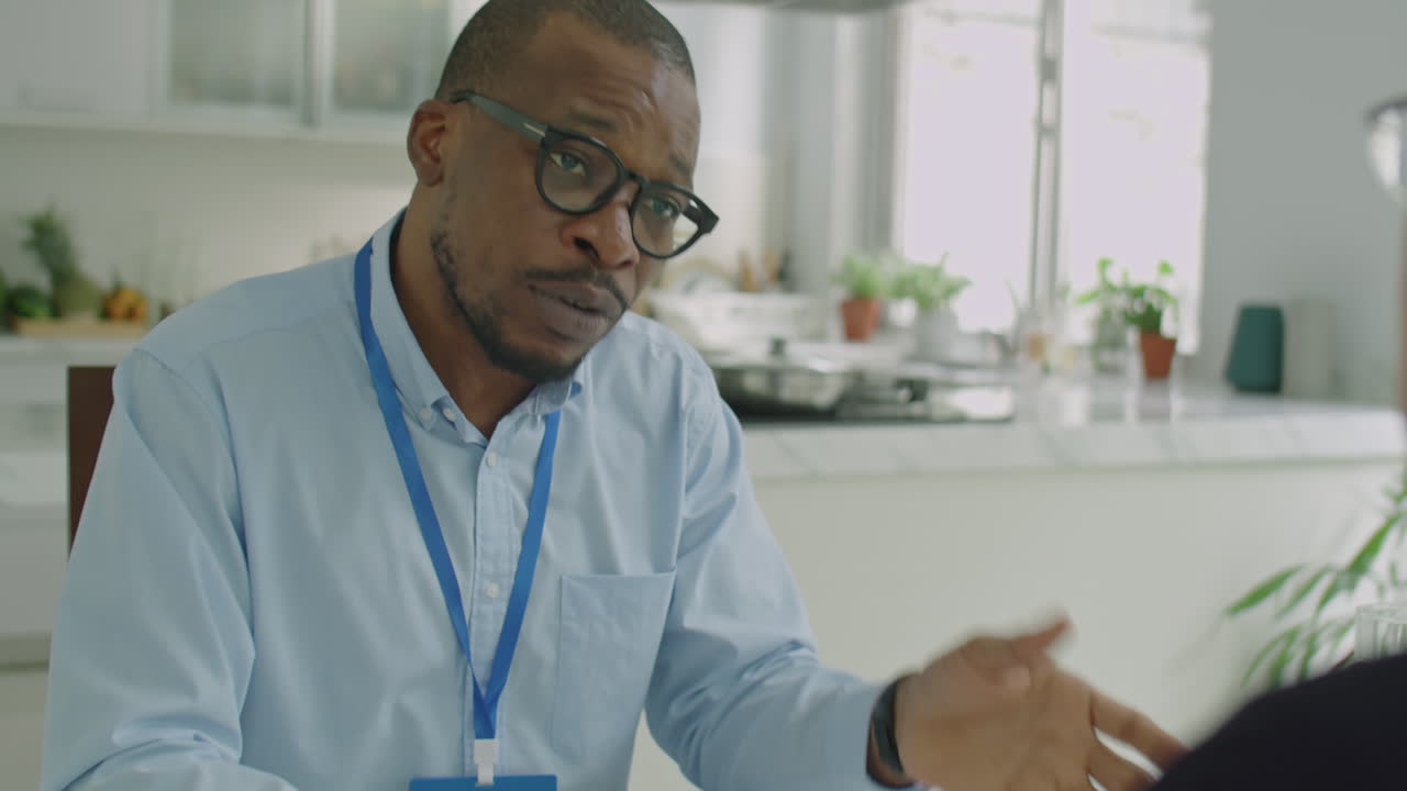 Black Engineer Explaining Startup Project to Colleague in Office