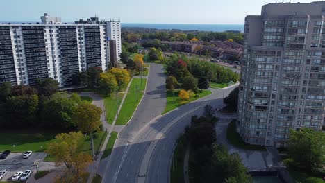 apartment buildings, roads, parks, trees and bus driving in beautiful city neighborhood near waterfront