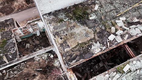 remains of an old buildings with some broken parts. shooting in motion on the area of an abandoned plant. aerial perspective.