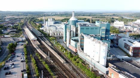 Industrial-chemical-manufacturing-factory-next-to-Warrington-Bank-Quay-train-tracks-aerial-slow-descending-view