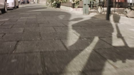 back walking ground view with shadow during sunset light ray in europe neighborhood residential area pedestrian front yard with man people walking passing by