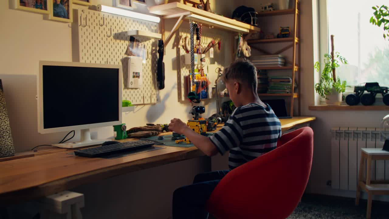 Boy working on a model in his room