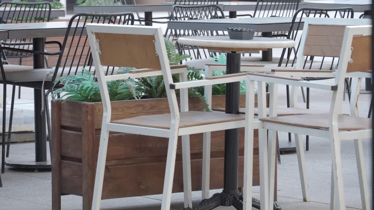 Outdoor Cafe Seating Area with Tables and Chairs
