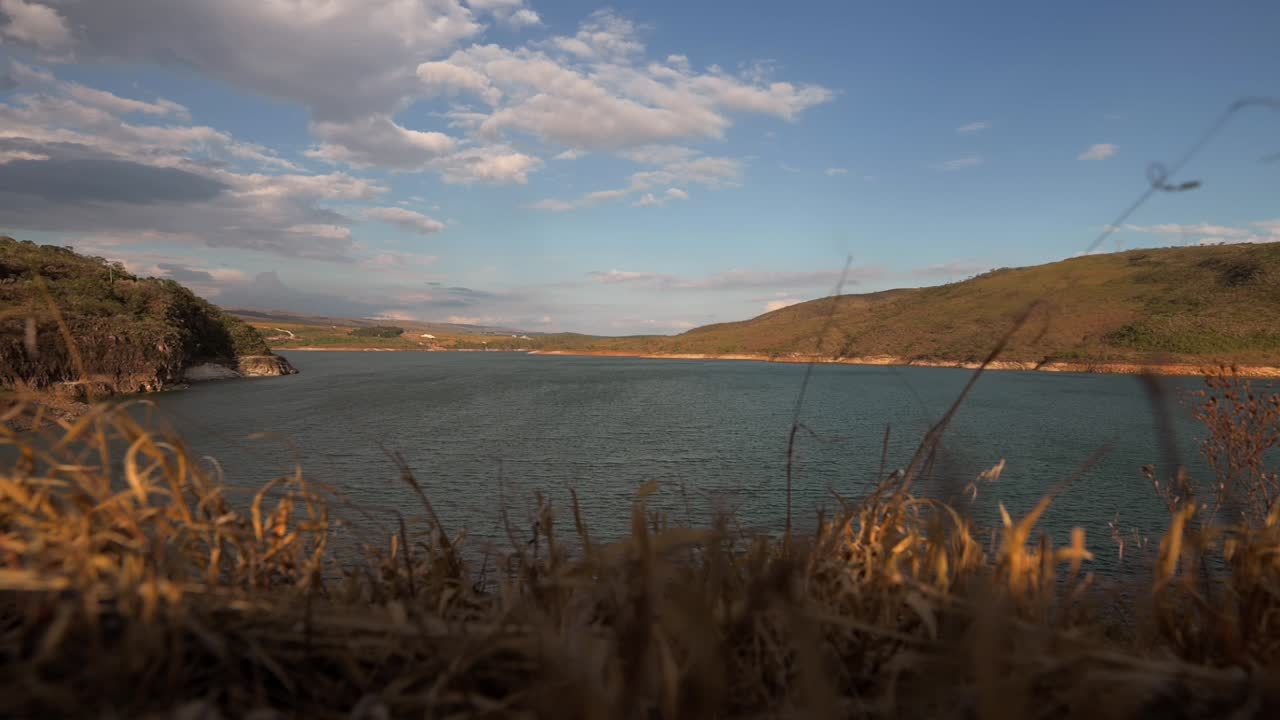 Breathtaking view of the coastline with hills and clear blue water, captured in Furnas, Minas Gerais